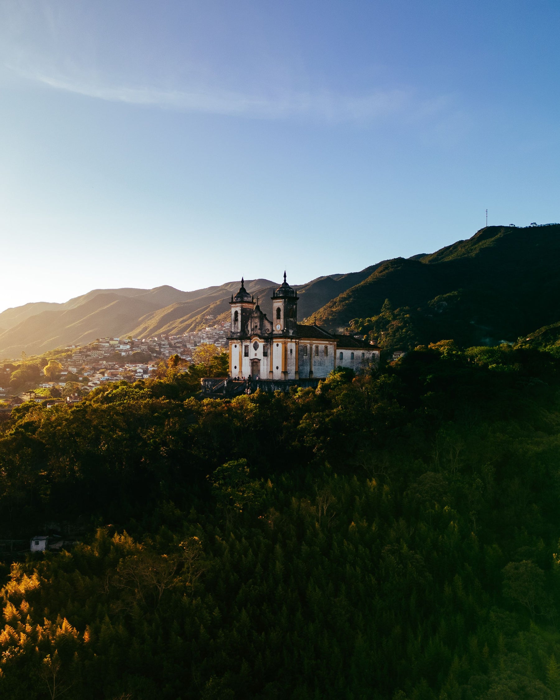 A historic church on a hillside in warm evening light