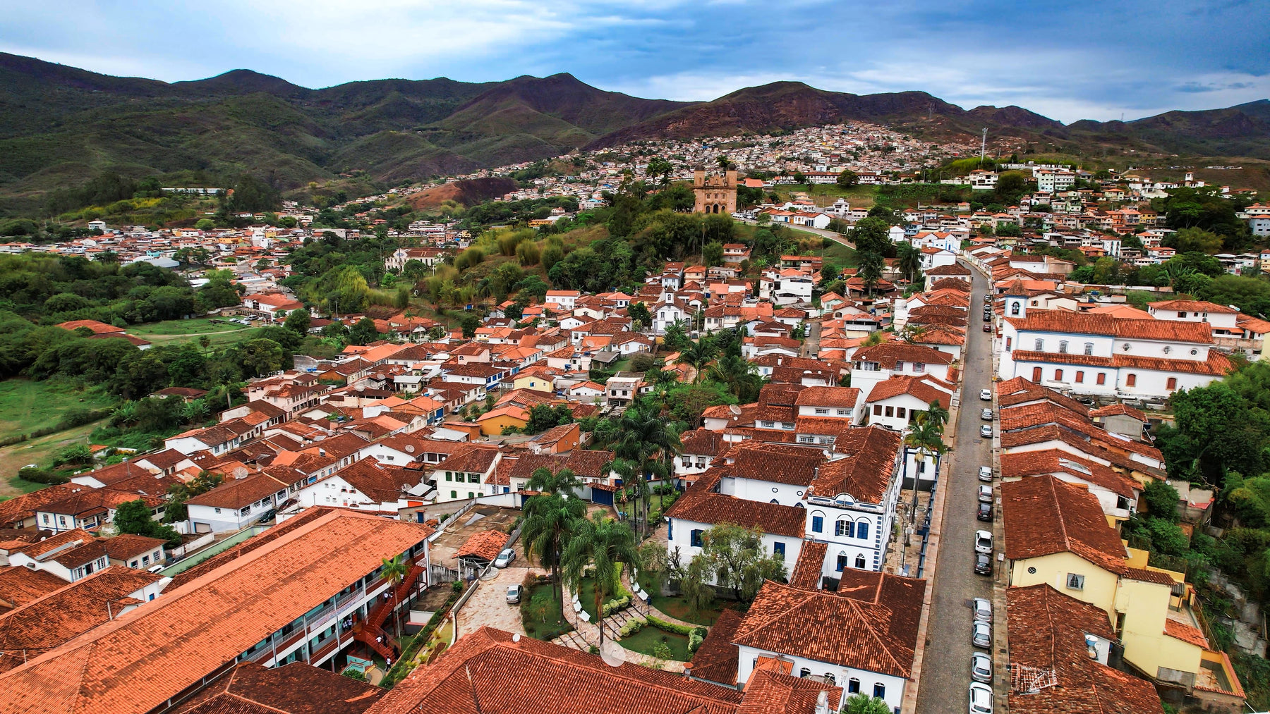 A panoramic view of a town with red tiled rooftops
