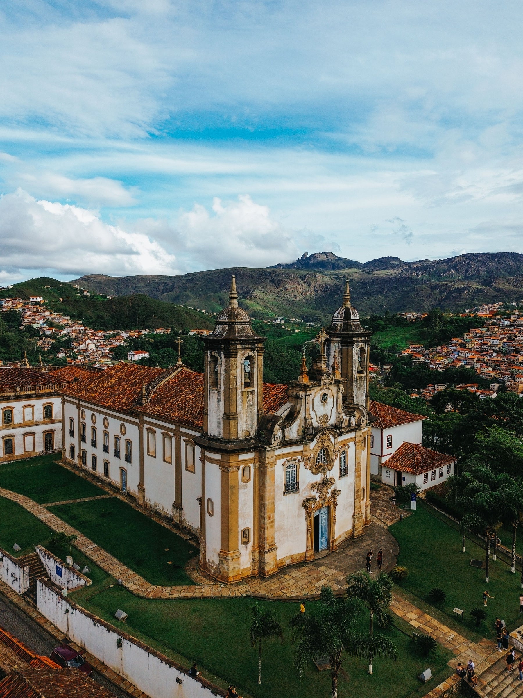 An ornate historic church surrounded by hills and houses